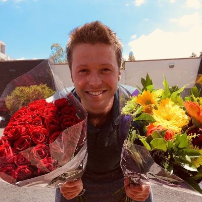 Harisson Wagner is holding two flower bouquet in the picture.